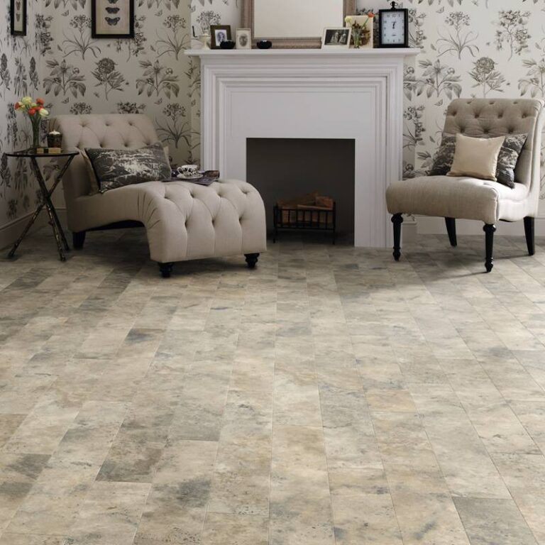 Square image of an Art Select Travertine Gallatin Long tile laid in a room with a fire place and two chairs